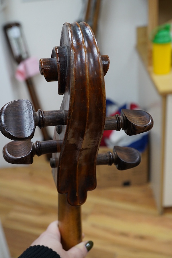 A cased late 19th century German? cello, body length 75cm, together with two bows. Condition - fair to good.